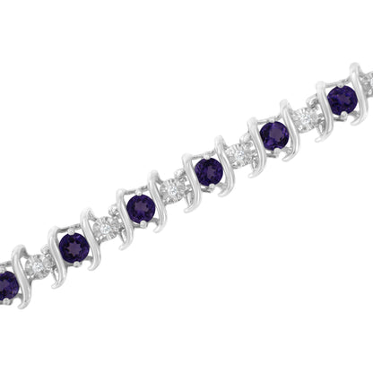 Diagonal close-up of a white metal bracelet featuring alternating round purple and white gemstones in prong settings.