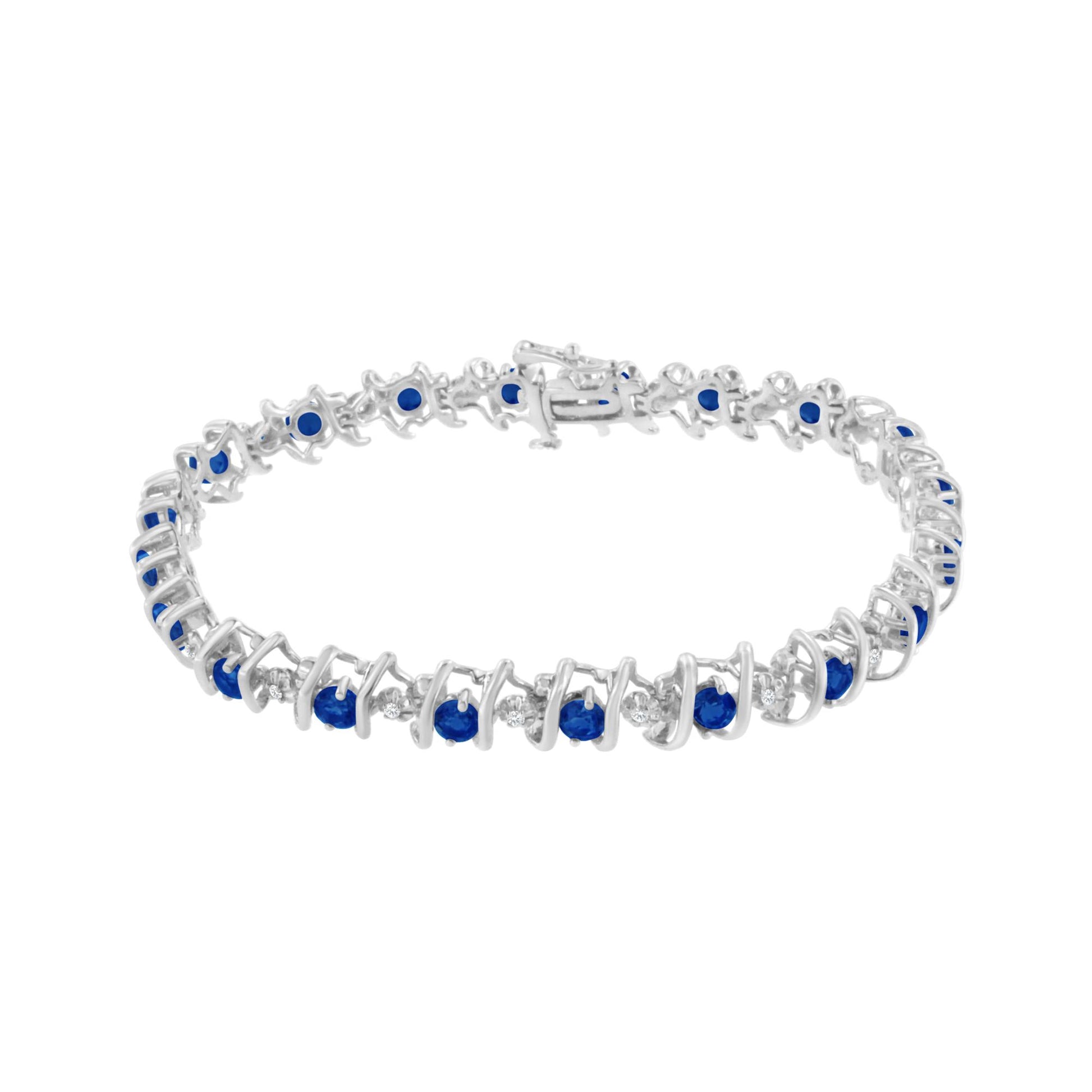 White metal bracelet with alternating round blue and white gemstones in prong and miracle settings, shown in a front-facing angle.
