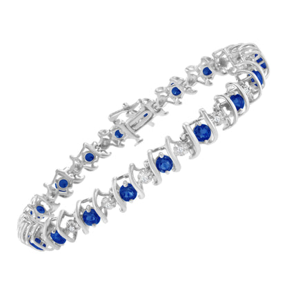 White metal bracelet with alternating round blue and white gemstones, shown at an angled top-down view.