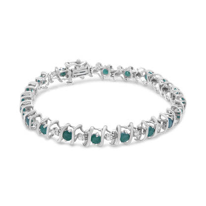 Close-up front angle of a white metal bracelet featuring alternating round white and green gemstones in prong settings.