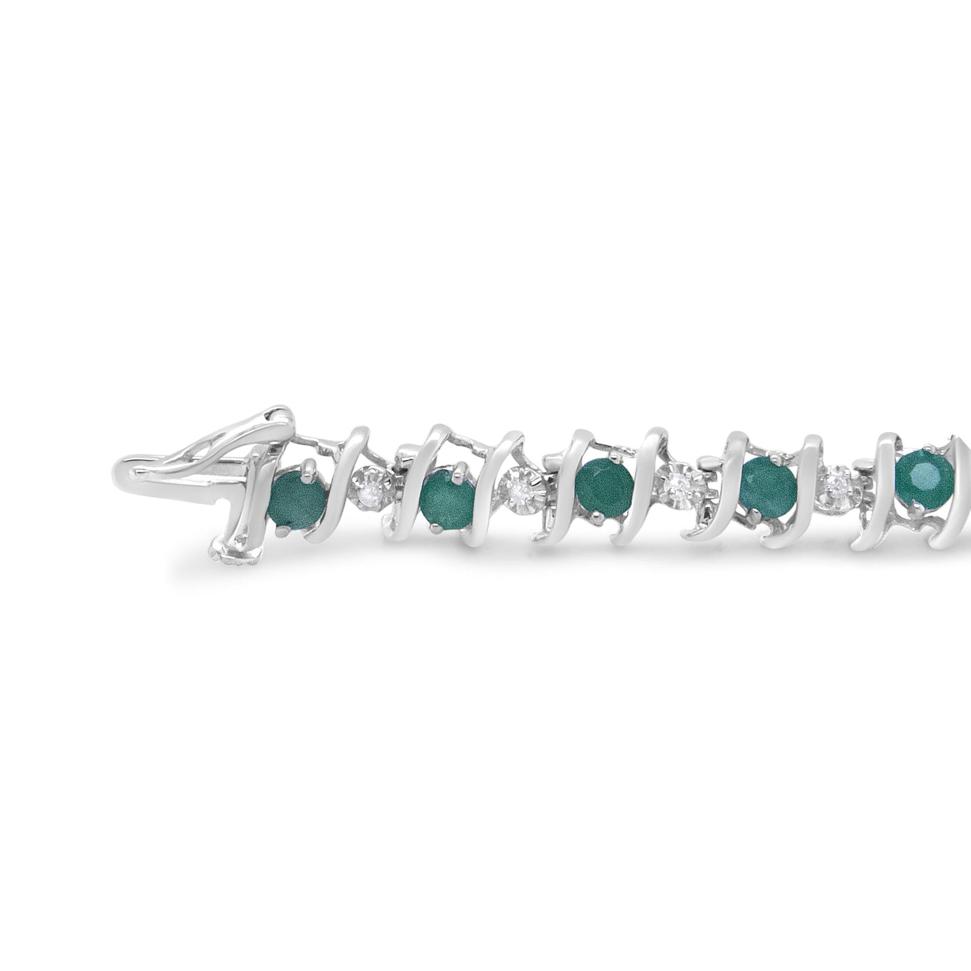 Close-up side angle of a white metal bracelet with alternating round green and white gemstones in prong settings.