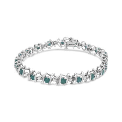 White metal bracelet with alternating round green and white gemstones in prong settings, shown at a slight angle on a white background.