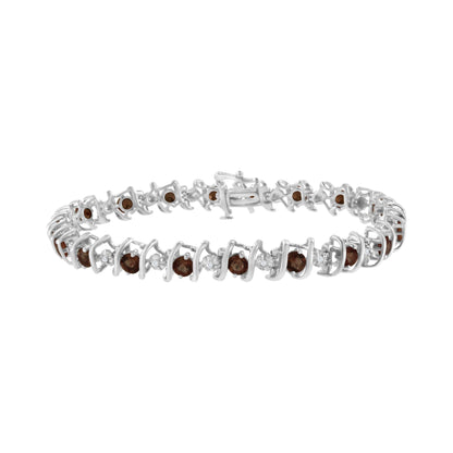 White metal bracelet with alternating round red gemstones in prong settings and round white gemstones in miracle settings, shown from a side angle on a white background.