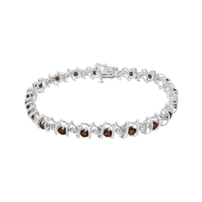White metal bracelet with alternating round red gemstones in prong settings and round white gemstones in miracle settings, shown in a front angle view.