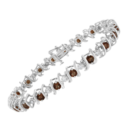 White metal bracelet viewed at an angle, featuring round white gemstones in a miracle setting alternating with round red gemstones in prong settings.