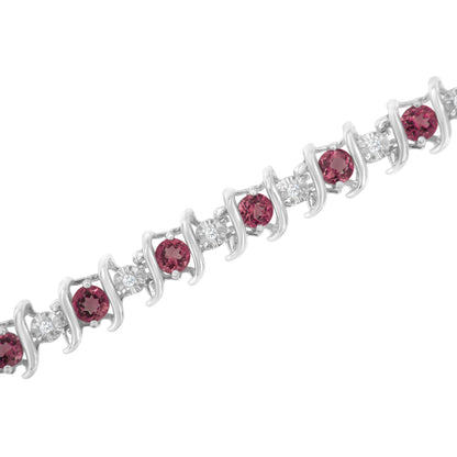 Close-up, angled view of a white metal bracelet with alternating round pink and white gemstones in prong settings.