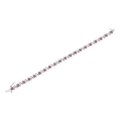 White metal bracelet with alternating round pink and white gemstones set in prong settings, shown from a top-down angle.