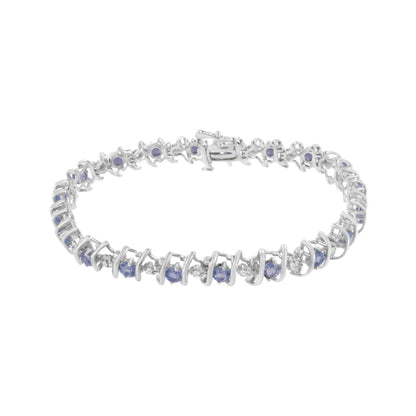 White metal bracelet with alternating round blue and white gemstones, shown from a front angle.