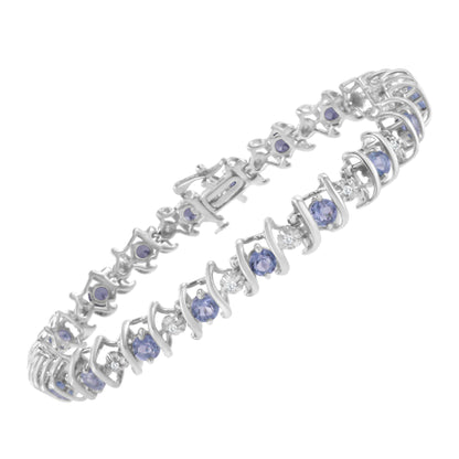 White bracelet viewed from an angled top-down perspective featuring alternating round blue and white gemstones set in a spiral design.