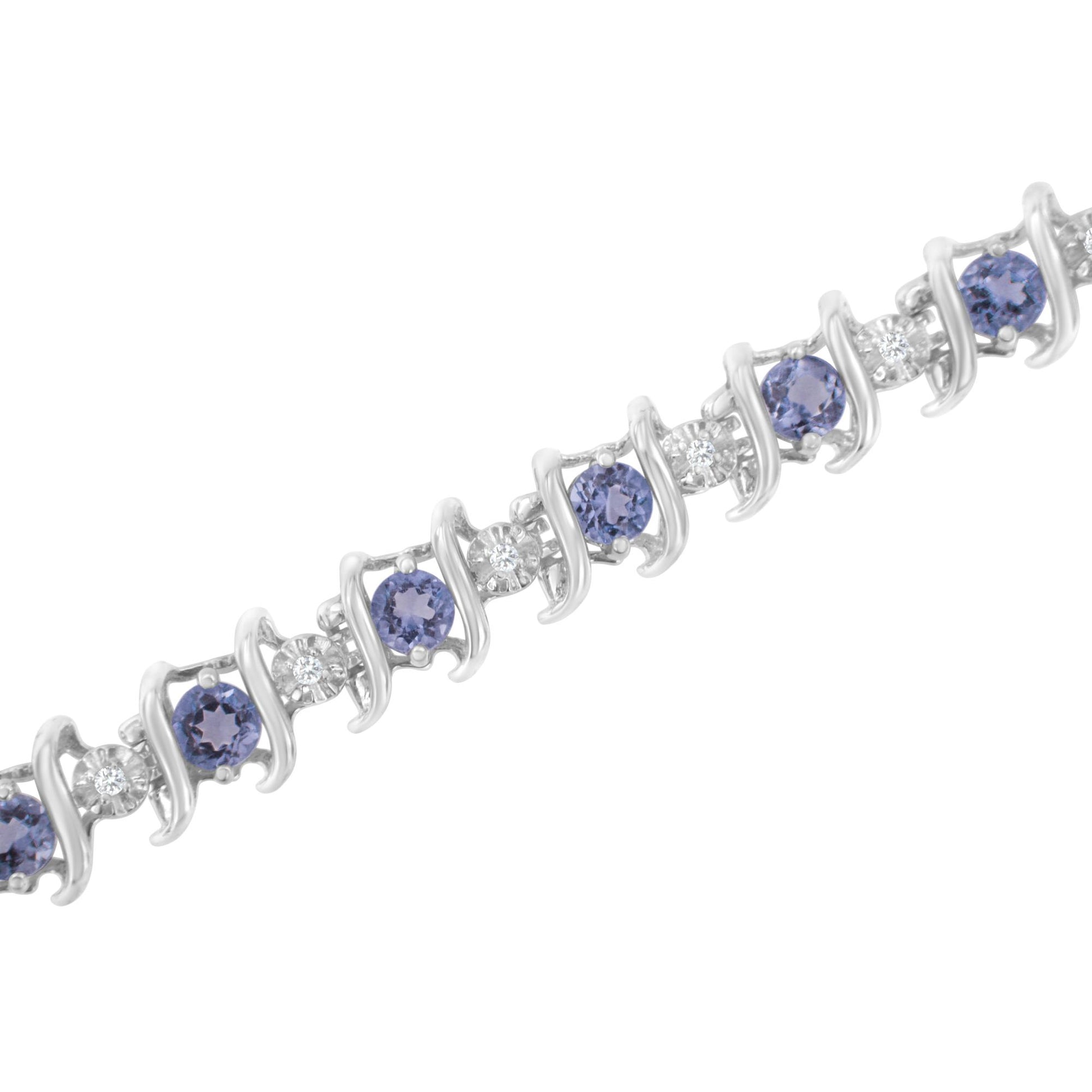 Close-up of a white metal bracelet with alternating round blue gemstones and round white gemstones, shot at a slight diagonal angle.
