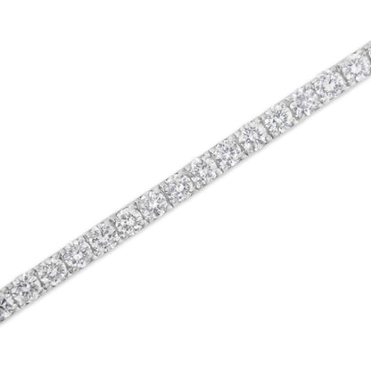 Close-up angled view of a white metal bracelet featuring a row of round white gemstones in prong settings.