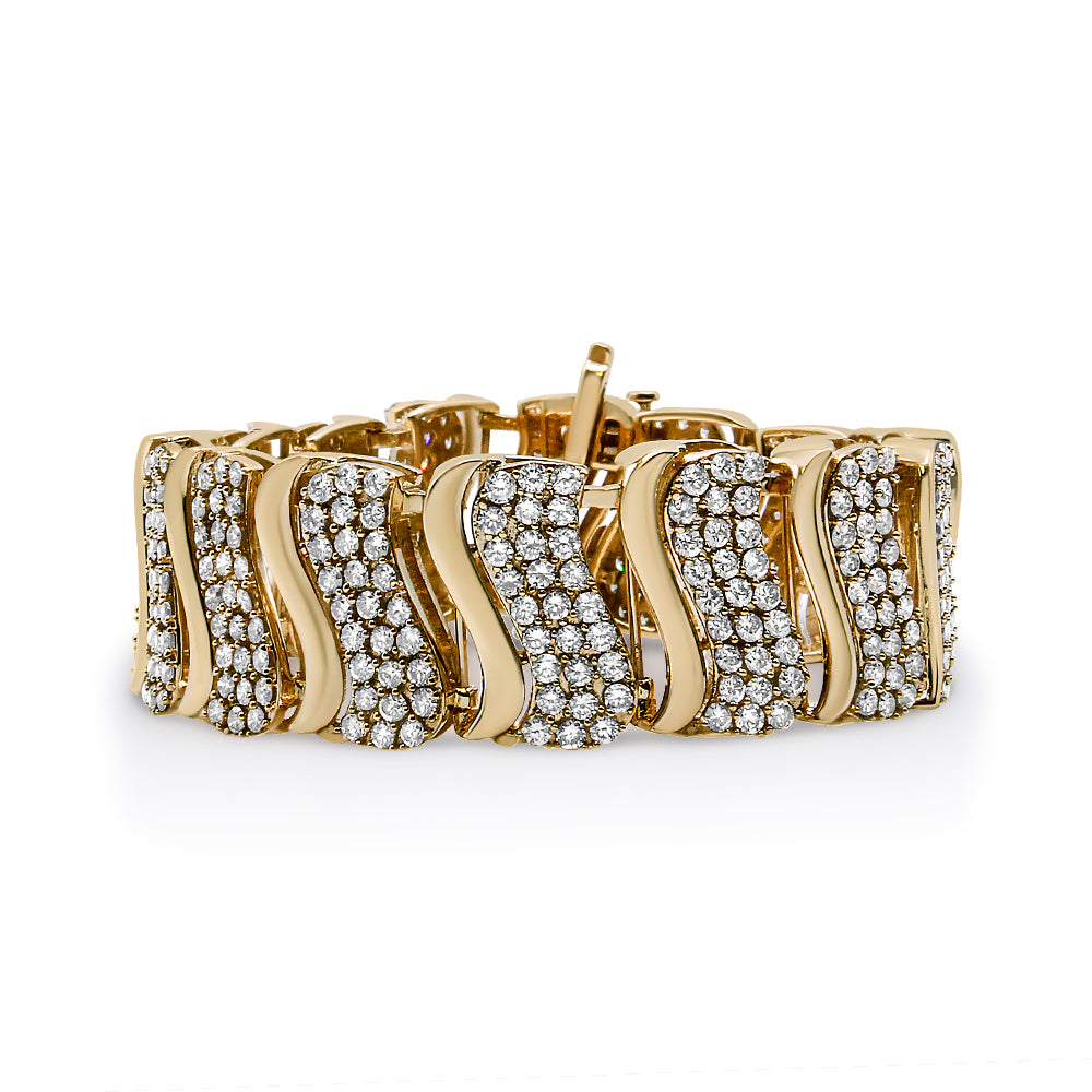 Yellow metal bracelet with curved sections alternating between smooth finish and rows of round white gemstones, shown from a front angle.