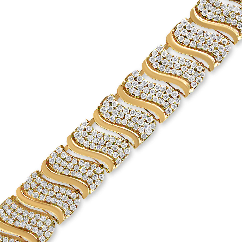 Close-up angled view of a yellow bracelet with a wavy design, featuring multiple rows of round white gemstones in prong settings.