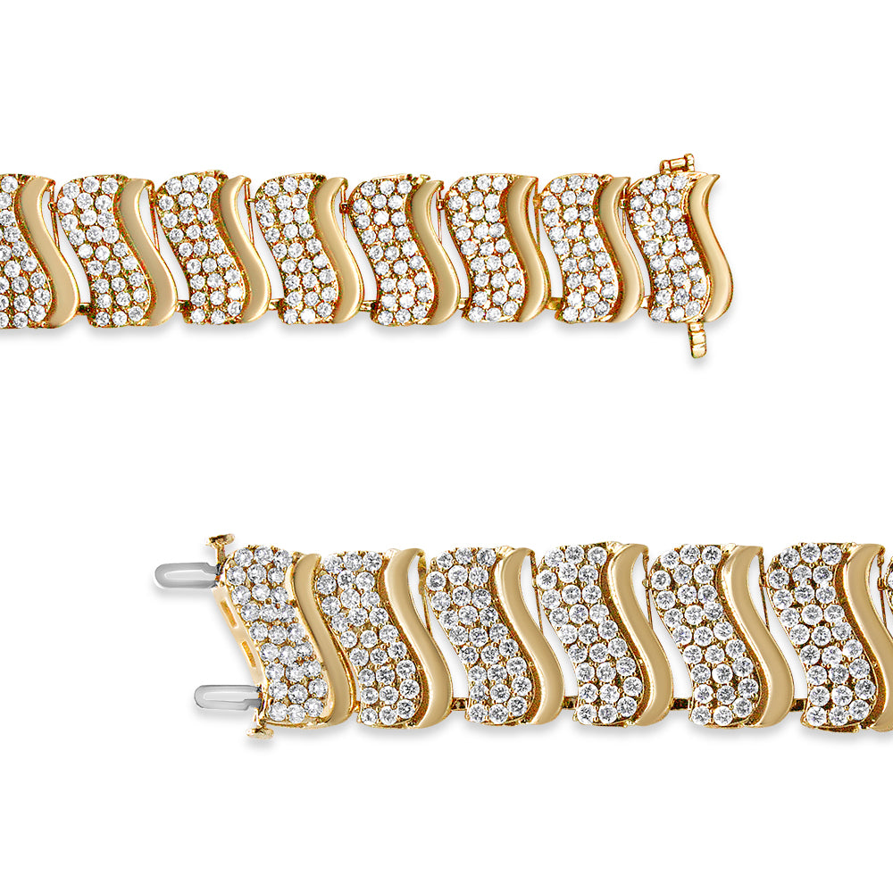 Close-up top view of a yellow bracelet featuring curved links each set with multiple round white gemstones in a prong setting, shown against a white background.