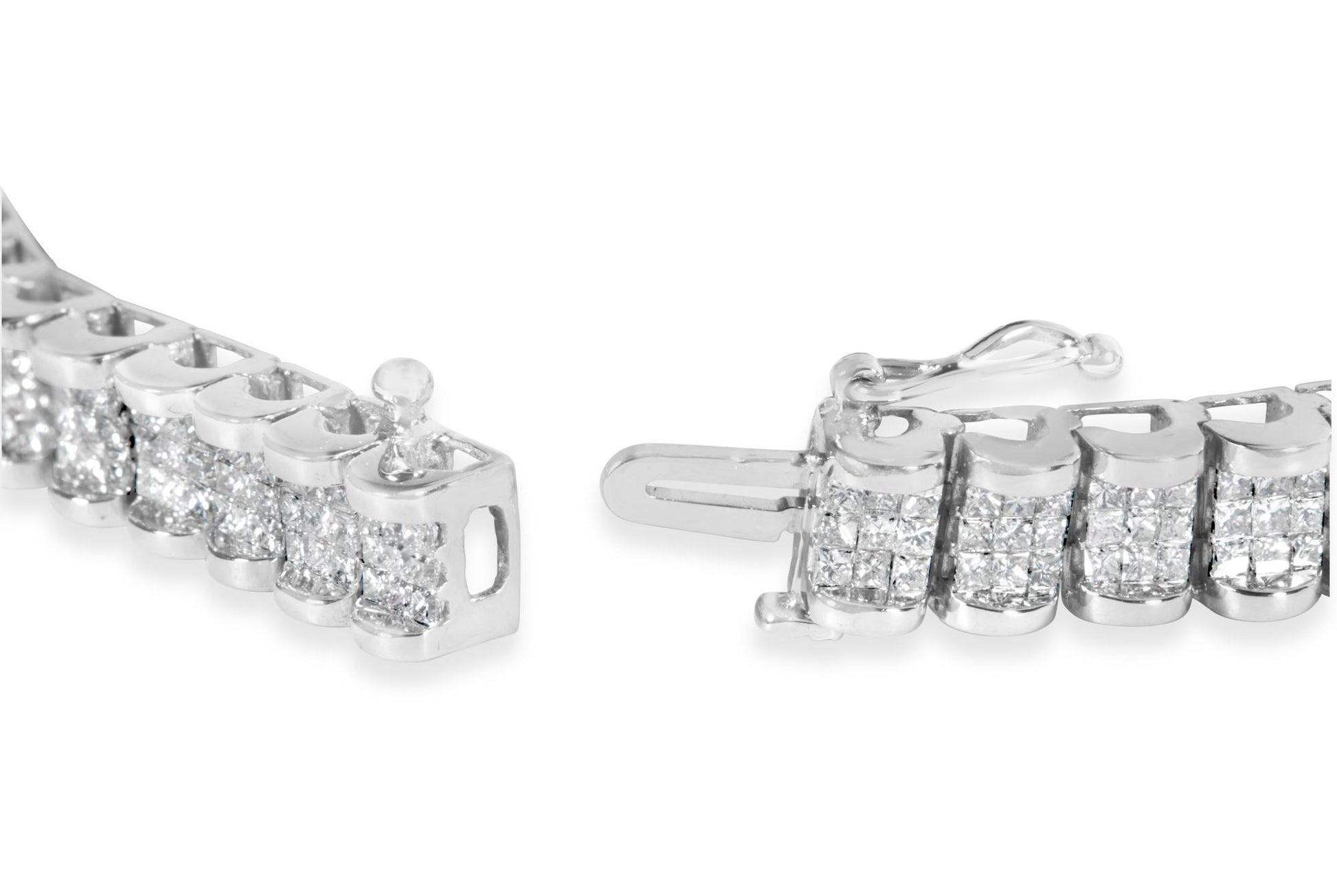 Close-up angled view of a white bracelet with multiple clusters of small princess-shaped white gemstones in an invisible setting, showing the clasp mechanism.