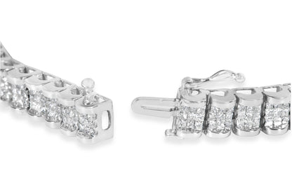 Close-up angled view of a white bracelet with multiple clusters of small princess-shaped white gemstones in an invisible setting, showing the clasp mechanism.