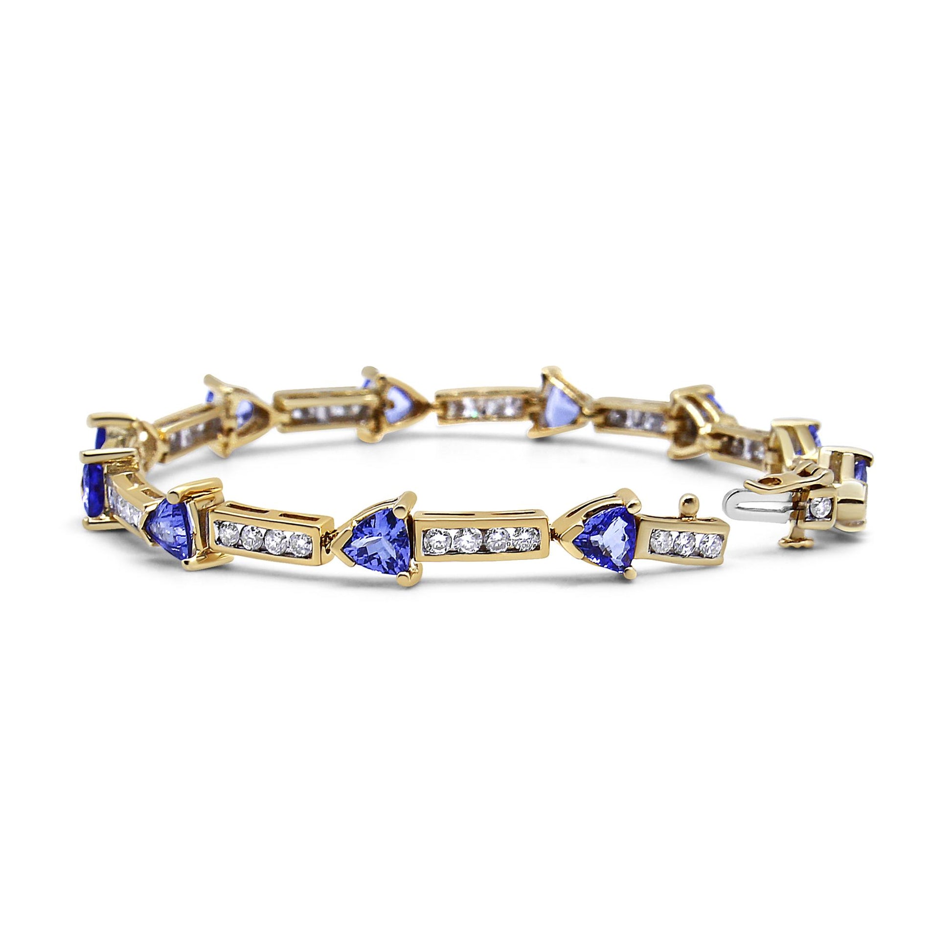 Yellow metal bracelet with alternating blue trillion-shaped gemstones in prong settings and rectangular sections with channel-set white round gemstones, shown from a front angled view.