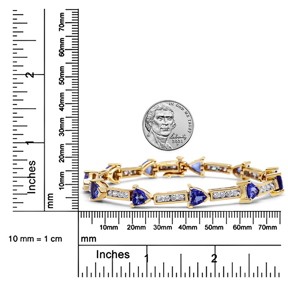 Yellow bracelet with alternating blue trillion-shaped gemstones and white round gemstones in channel setting, displayed on a scale and photographed from the front.