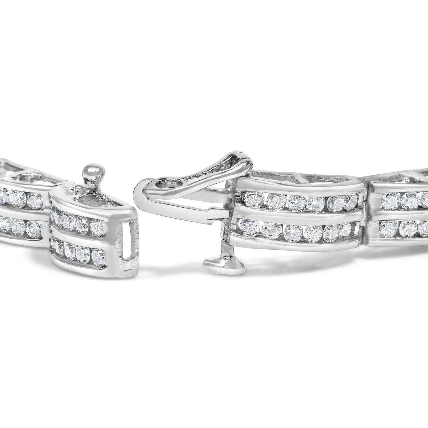 Close-up angled view of a white metal bracelet with round white gemstones in channel setting and a clasp open.