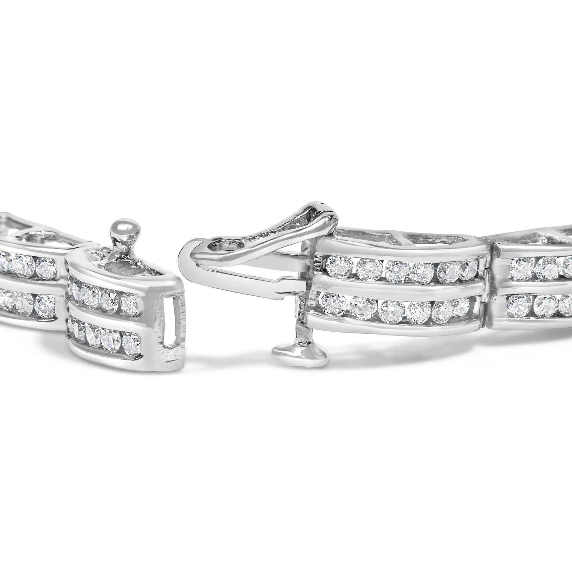 Close-up angled view of a white metal bracelet with round white gemstones in channel setting and a clasp open.