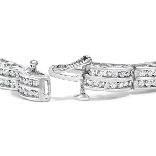 Close-up angled view of a white metal bracelet with round white gemstones in channel setting and a clasp open.