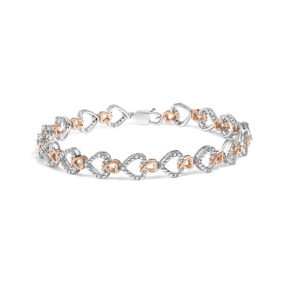 Bracelet shown from a front angle with alternating white and rose metal linked heart shapes, white pave-set round gemstones on white metal hearts.