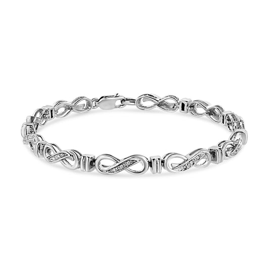 White metal bracelet with infinity-shaped links accented with small white gemstones, shown from a front angle.