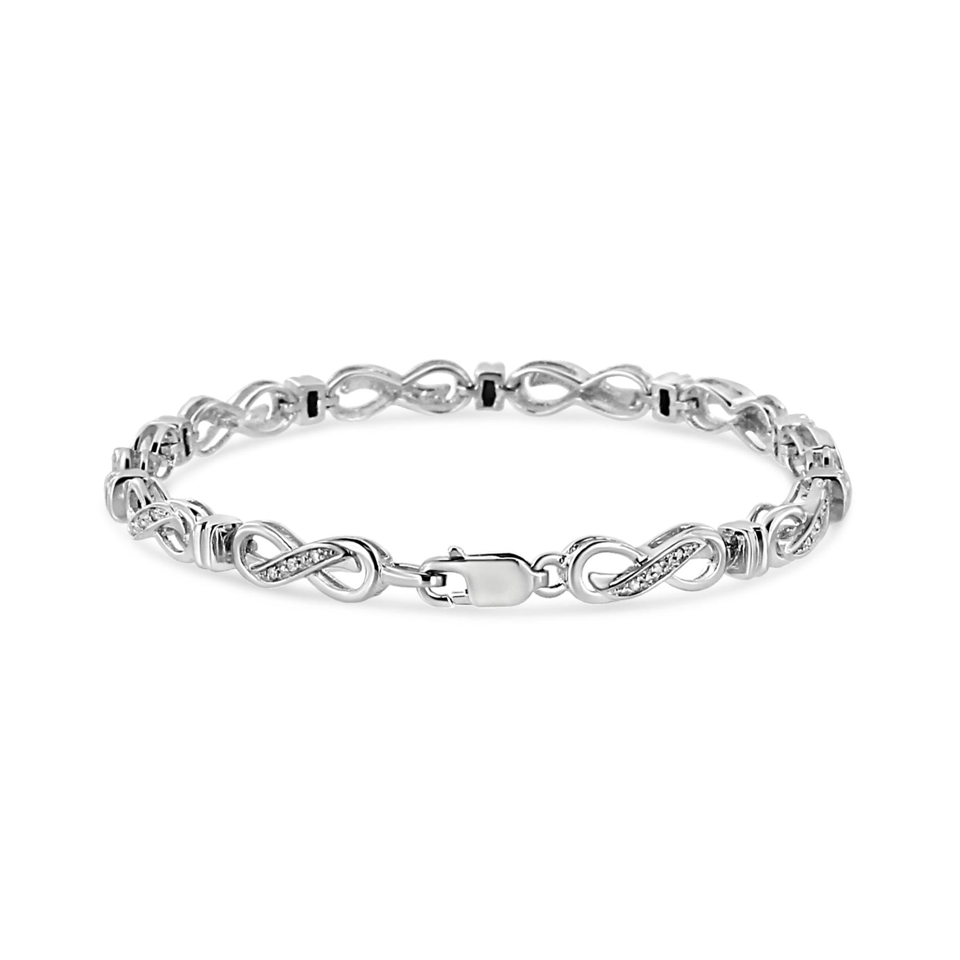 White bracelet with infinity-shaped links inlaid with round white gemstones in prong settings, shown from a front angle.