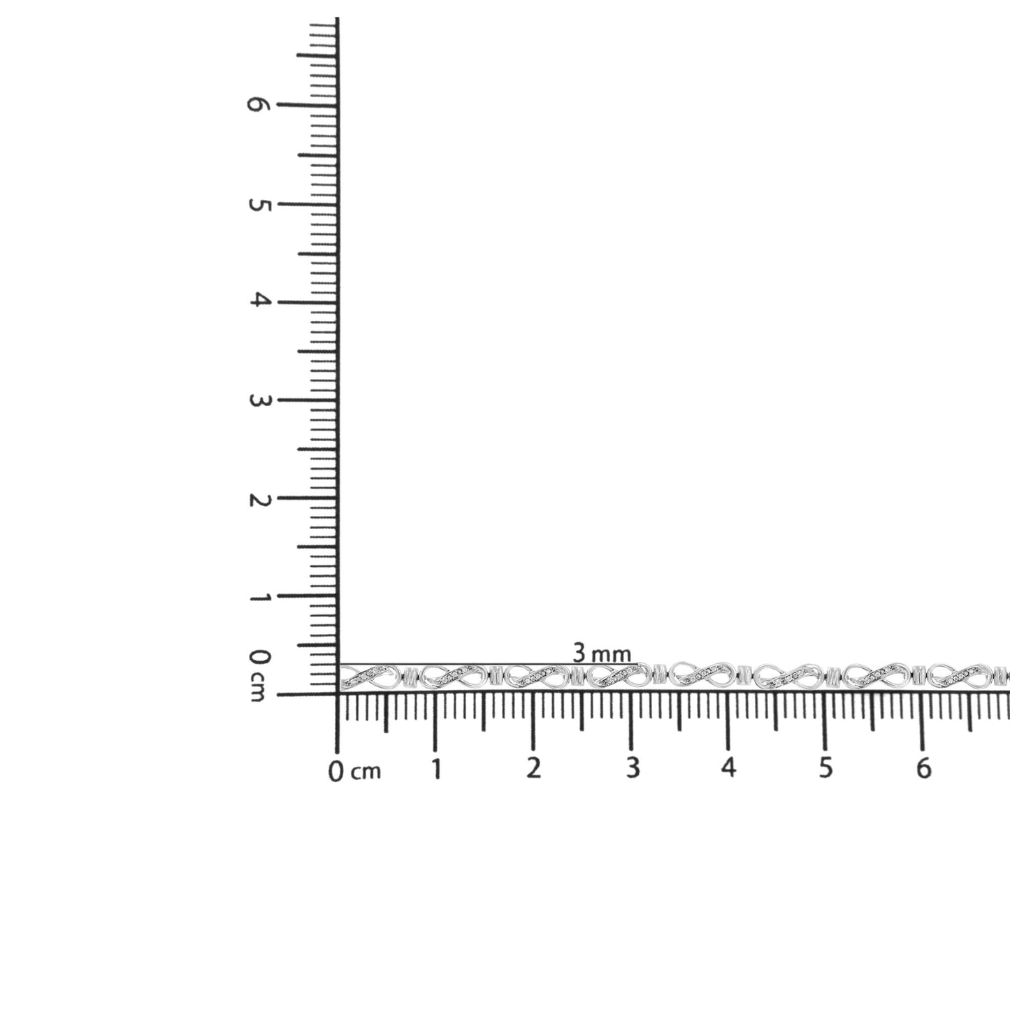 Bracelet with white metal and round white gemstones in prong setting, shown on ruler for size reference, top-down angle.