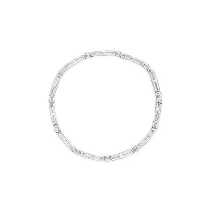 Top view of a white metal bracelet with alternating rectangular and small round links, featuring channel-set baguette-shaped and bezel-set round white gemstones.