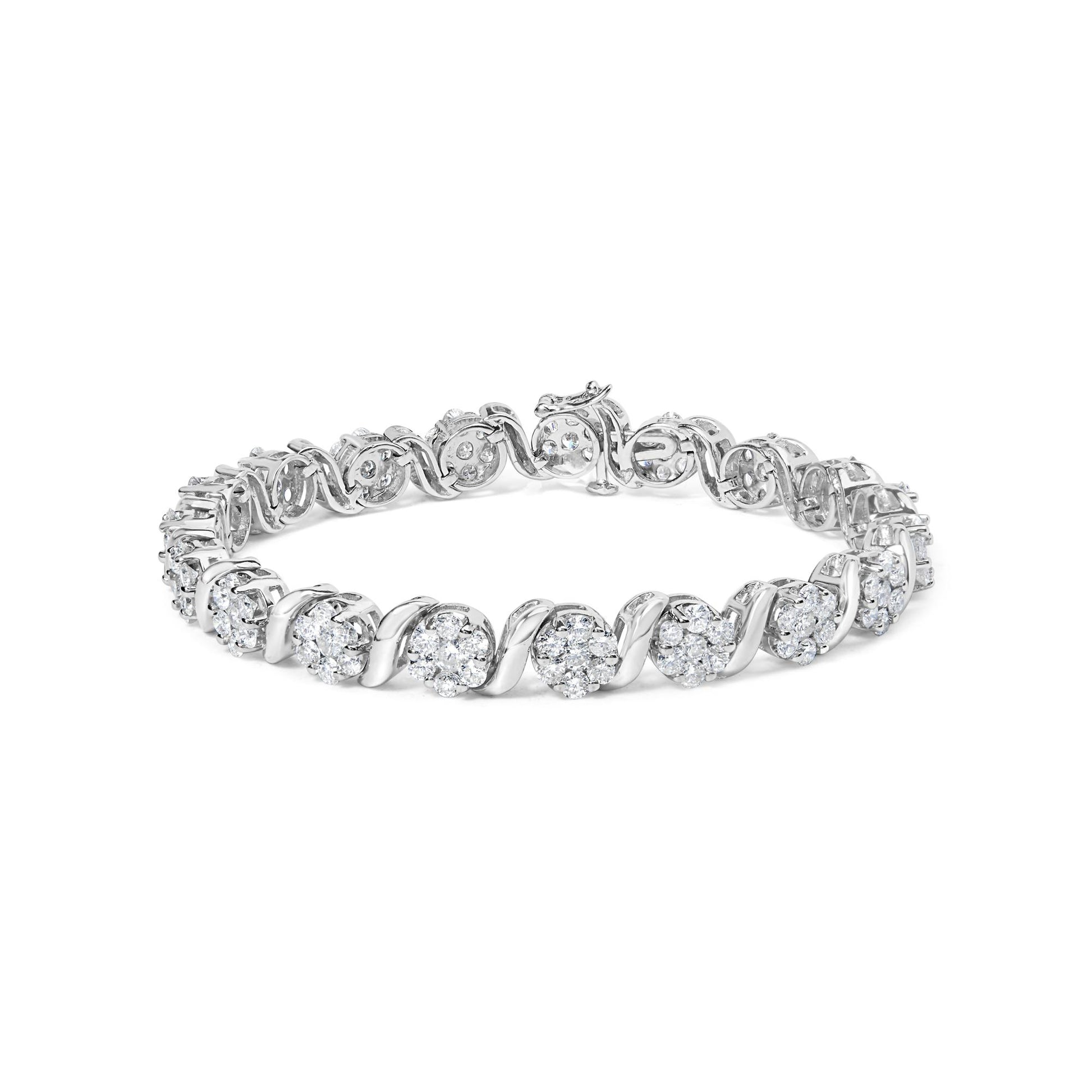 White metal bracelet with clusters of round white gemstones in prong settings, shown at a slight angle on a white background.