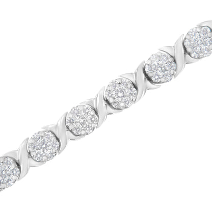 Close-up diagonal view of a white metal bracelet featuring round white gemstones in prong settings with alternating swirl design links.