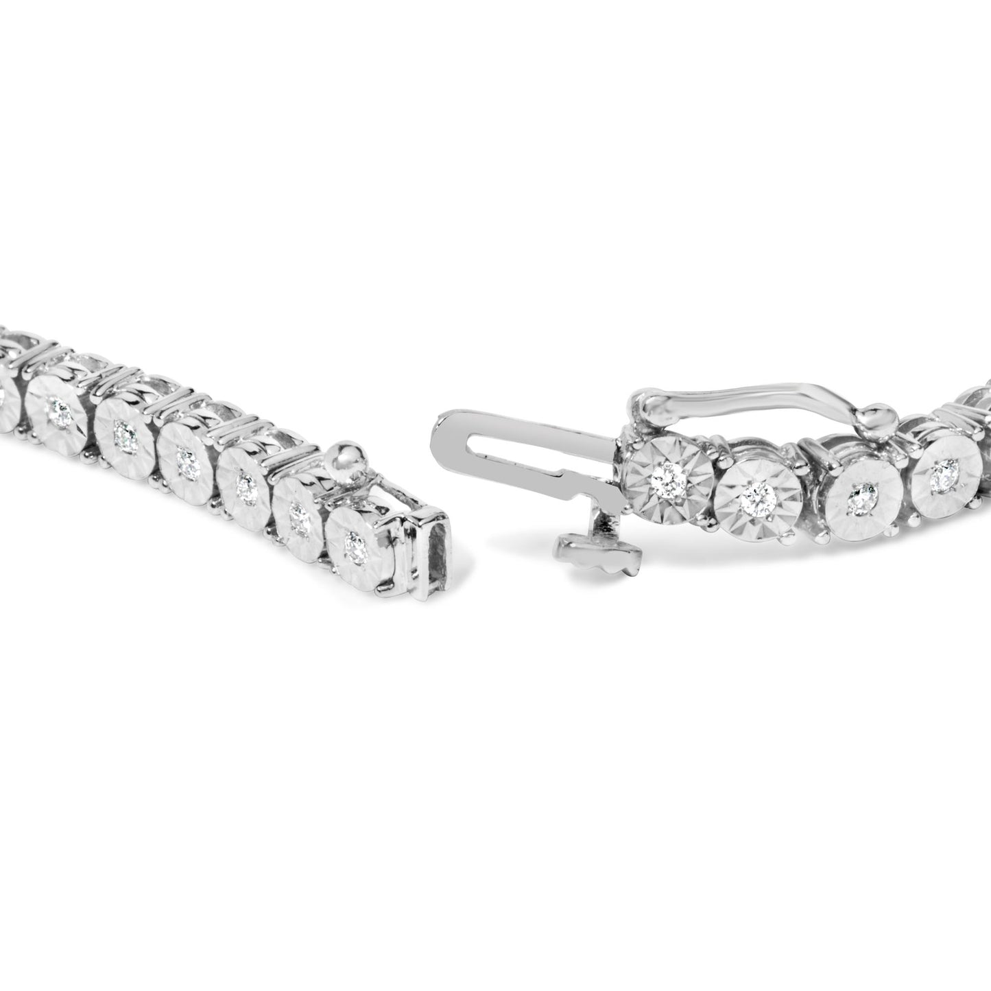 Close-up front angle of a white metal bracelet with round white gemstones in a miracle setting showing the clasp details.