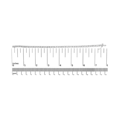 White metal bracelet with round white gemstones in a miracle setting, displayed flat on a ruler for size reference, top-down angle.