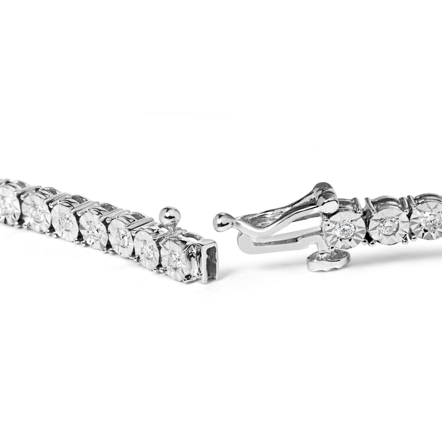 Close-up angle of a white metal bracelet with round white gemstones in miracle settings, showing the open clasp.