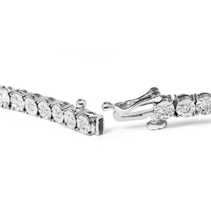 Close-up angle of a white metal bracelet with round white gemstones in miracle settings, showing the open clasp.