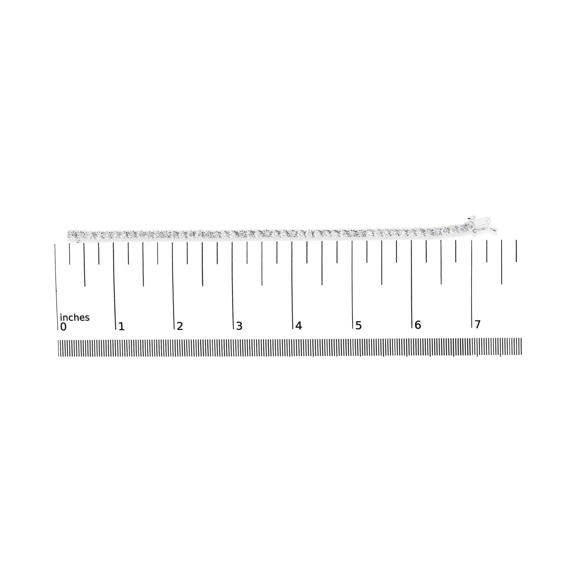 Top-down view of a white bracelet with round white gemstones in miracle setting, placed on a ruler for size reference.