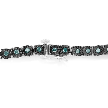 Close-up side angle of a white metal bracelet with round blue gemstones set in a miracle setting, showing the clasp mechanism.