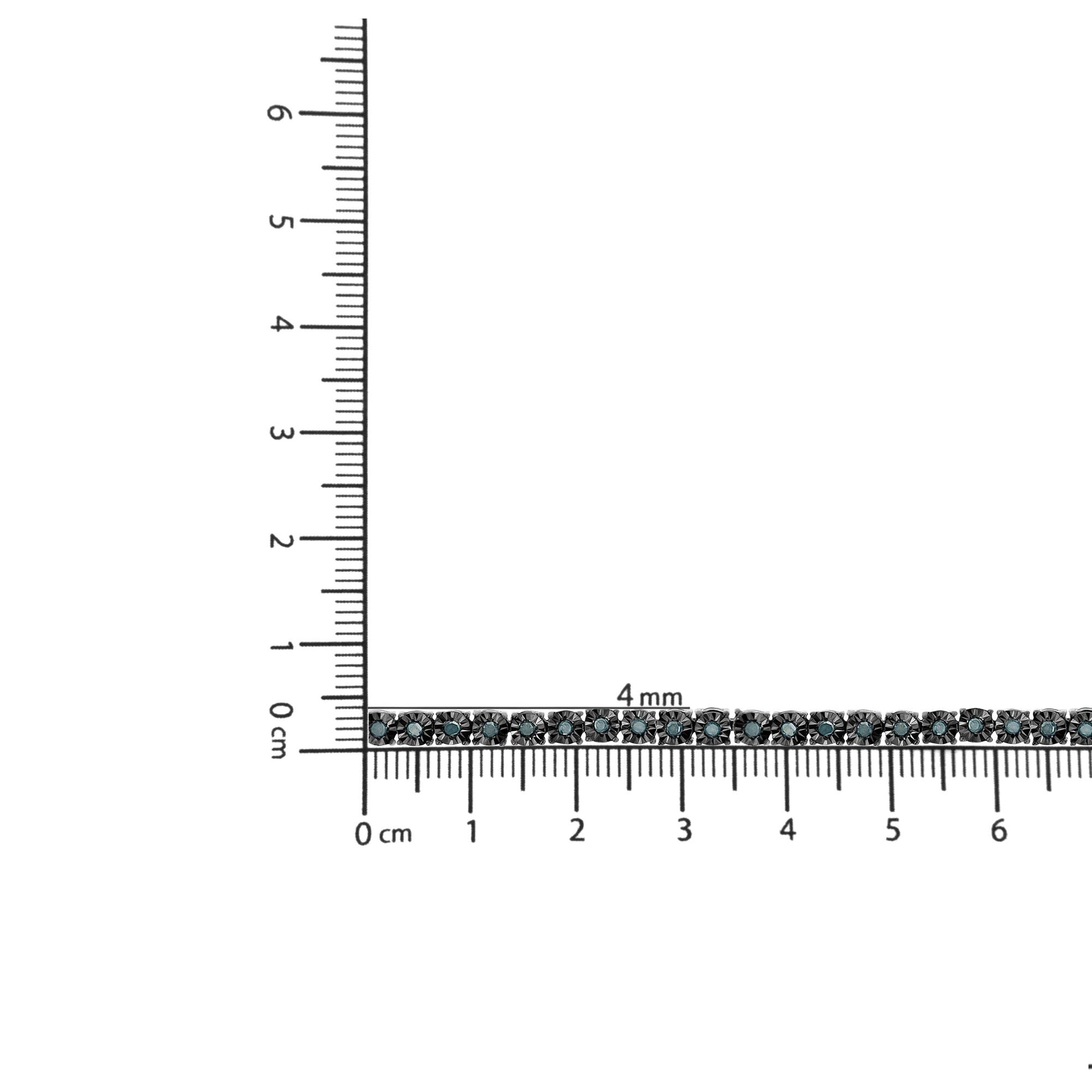 Close-up shot of a white metal bracelet with round blue gemstones in miracle settings, placed on a ruler for size reference.
