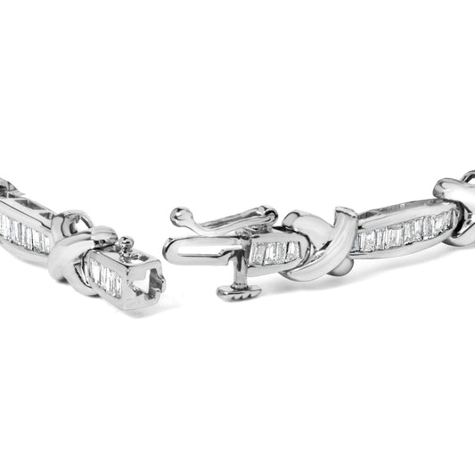 Close-up angle of a white metal bracelet with baguette-shaped white gemstones in a channel setting and a detailed clasp.