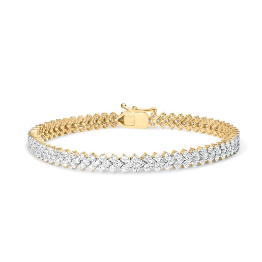 Yellow metal bracelet with two rows of prong-set round white gemstones, shown from a front angled view on a white background.