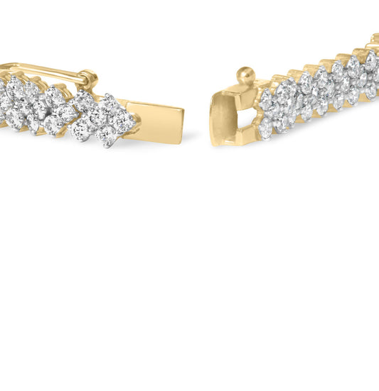 Close-up front angle of a yellow metal bracelet with prong-set round white gemstones.