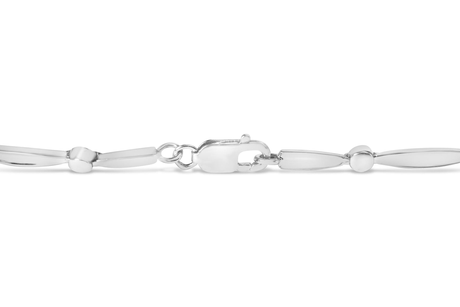 Close-up side view of a white metal bracelet with smooth, elongated oval links and a clasp, featuring a section with three round white gemstones in a channel setting.
