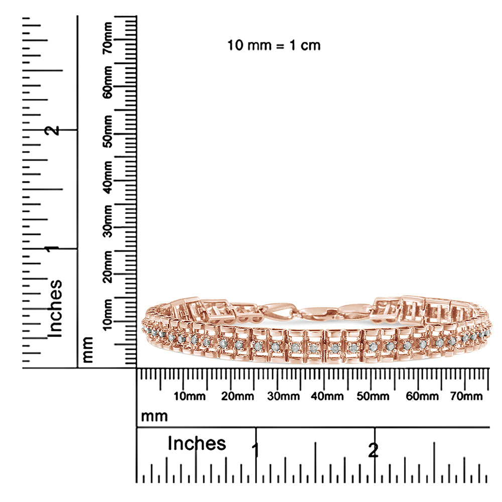 Rose metal bracelet with two rows of round white gemstones in prong settings, shown from a front angle on a ruler for size reference.