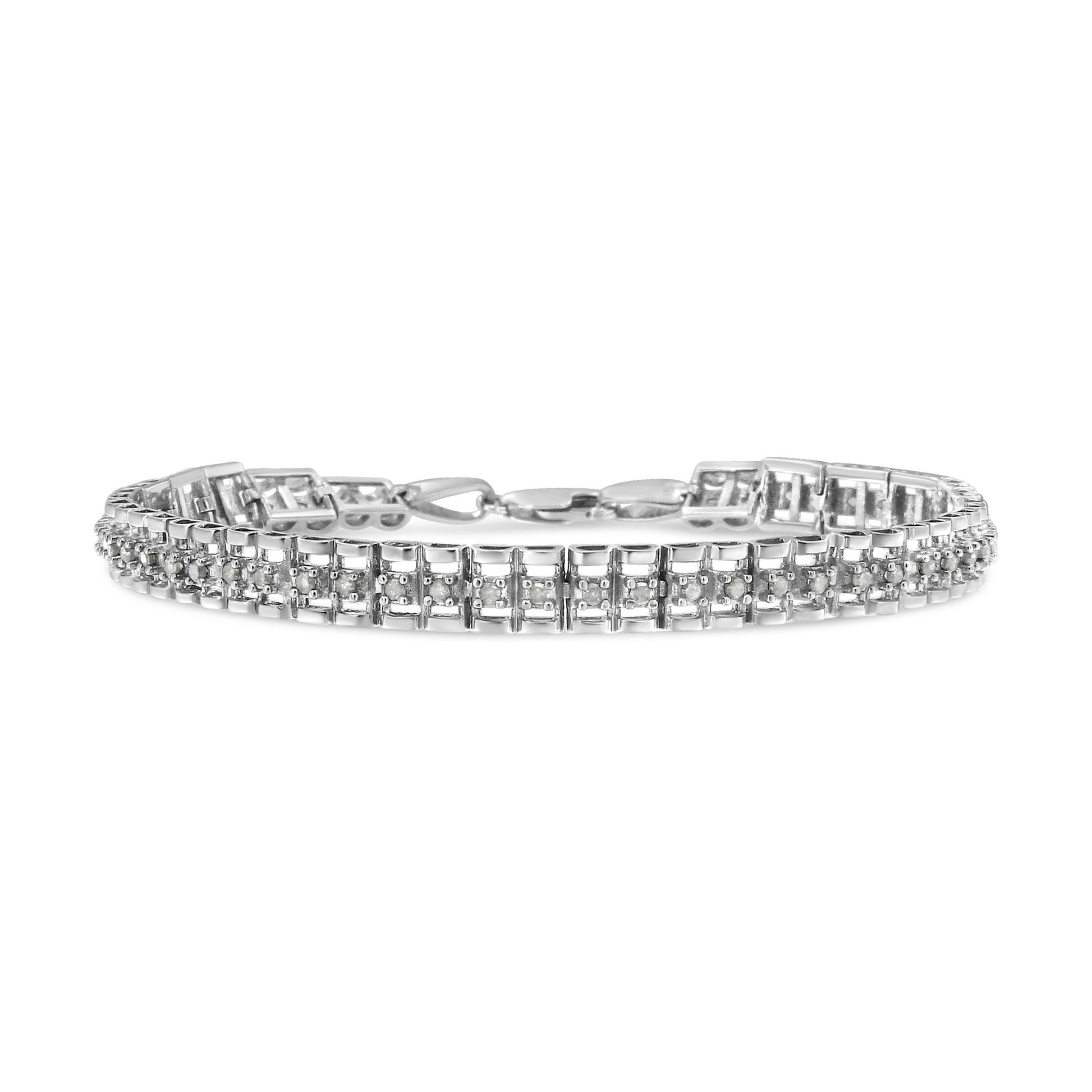 Front angle view of a white metal bracelet with rows of round white gemstones in prong settings.