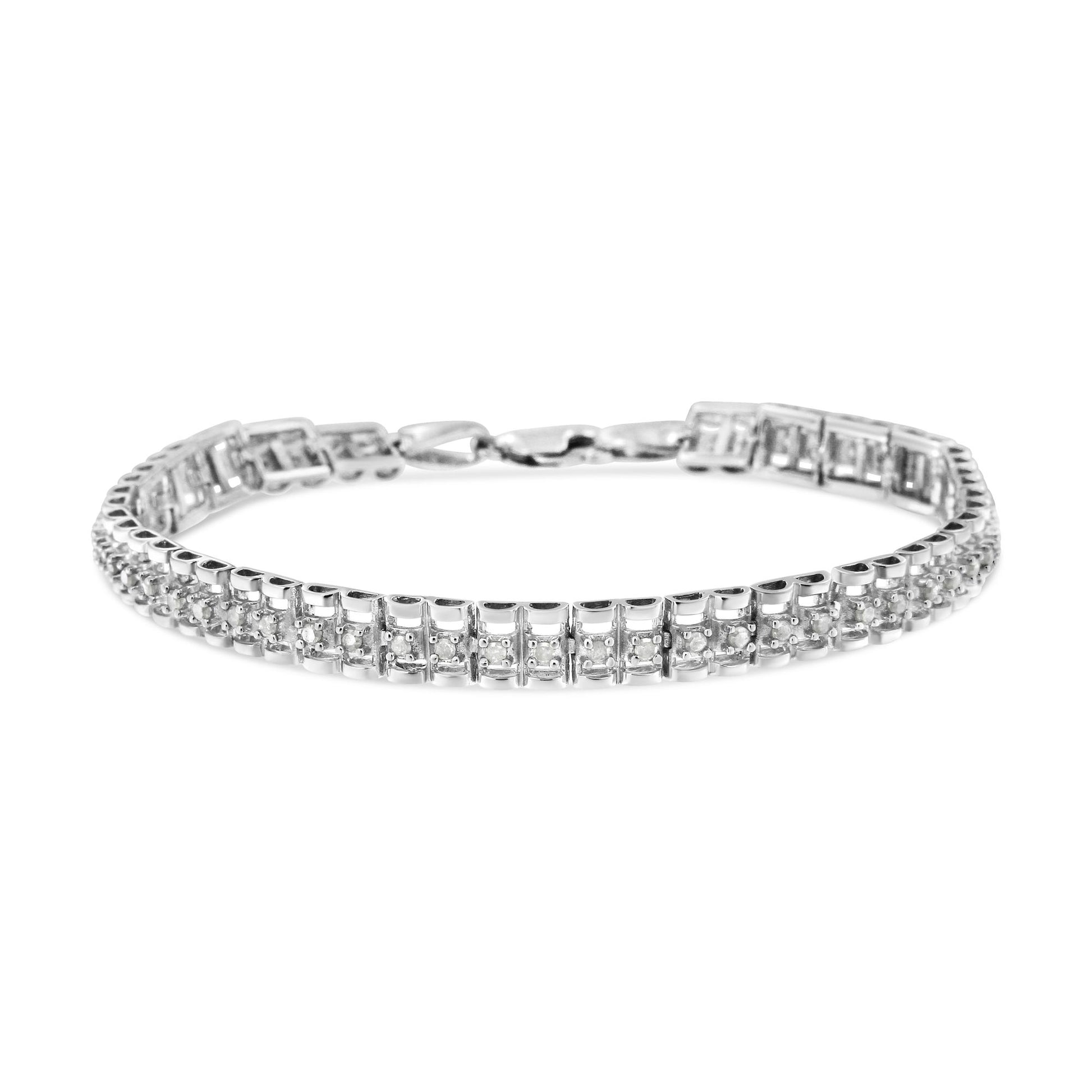White metal bracelet with two rows of round white gemstones in prong settings, shown from front angle on white background.
