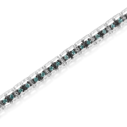 Diagonal close-up of a white metal bracelet with round blue gemstones in prong settings.