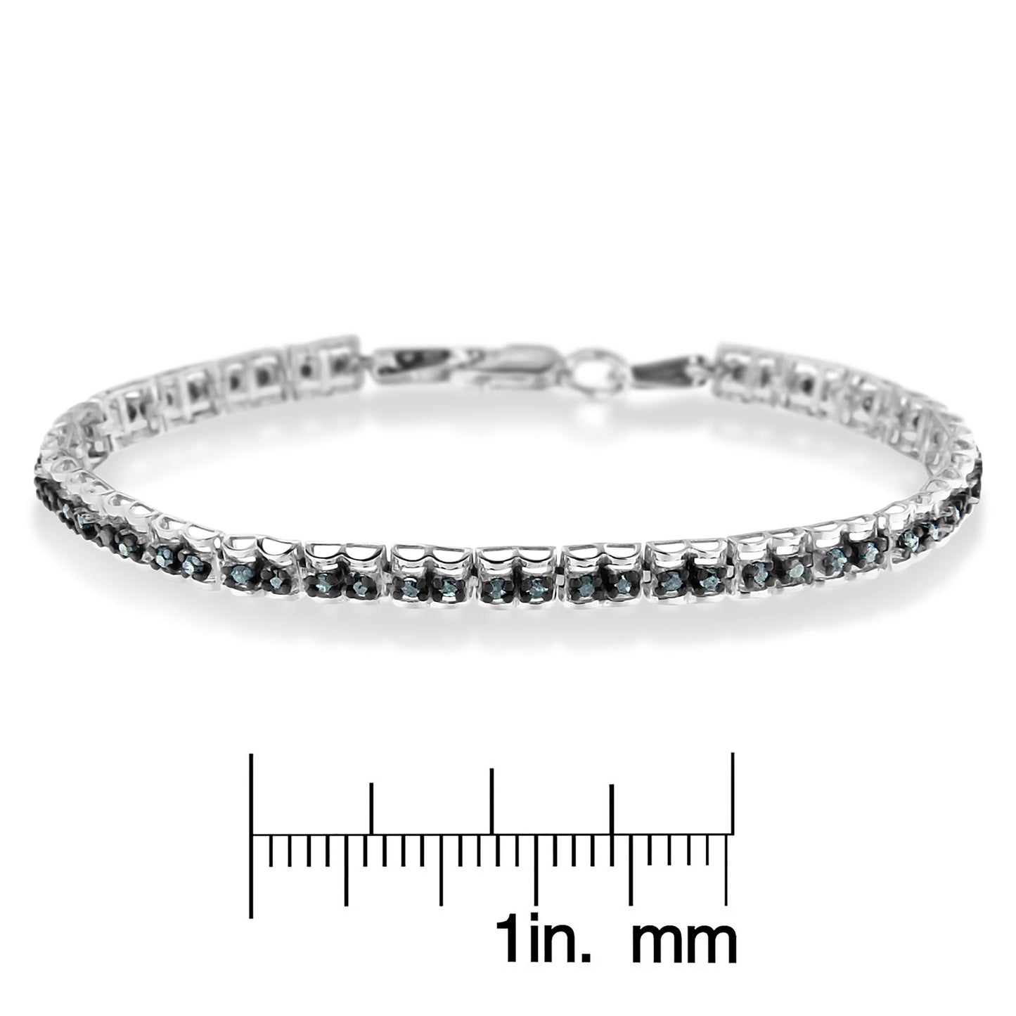 White metal bracelet with round blue gemstones in prong settings, photographed from a side angle, displayed above a ruler for size reference.