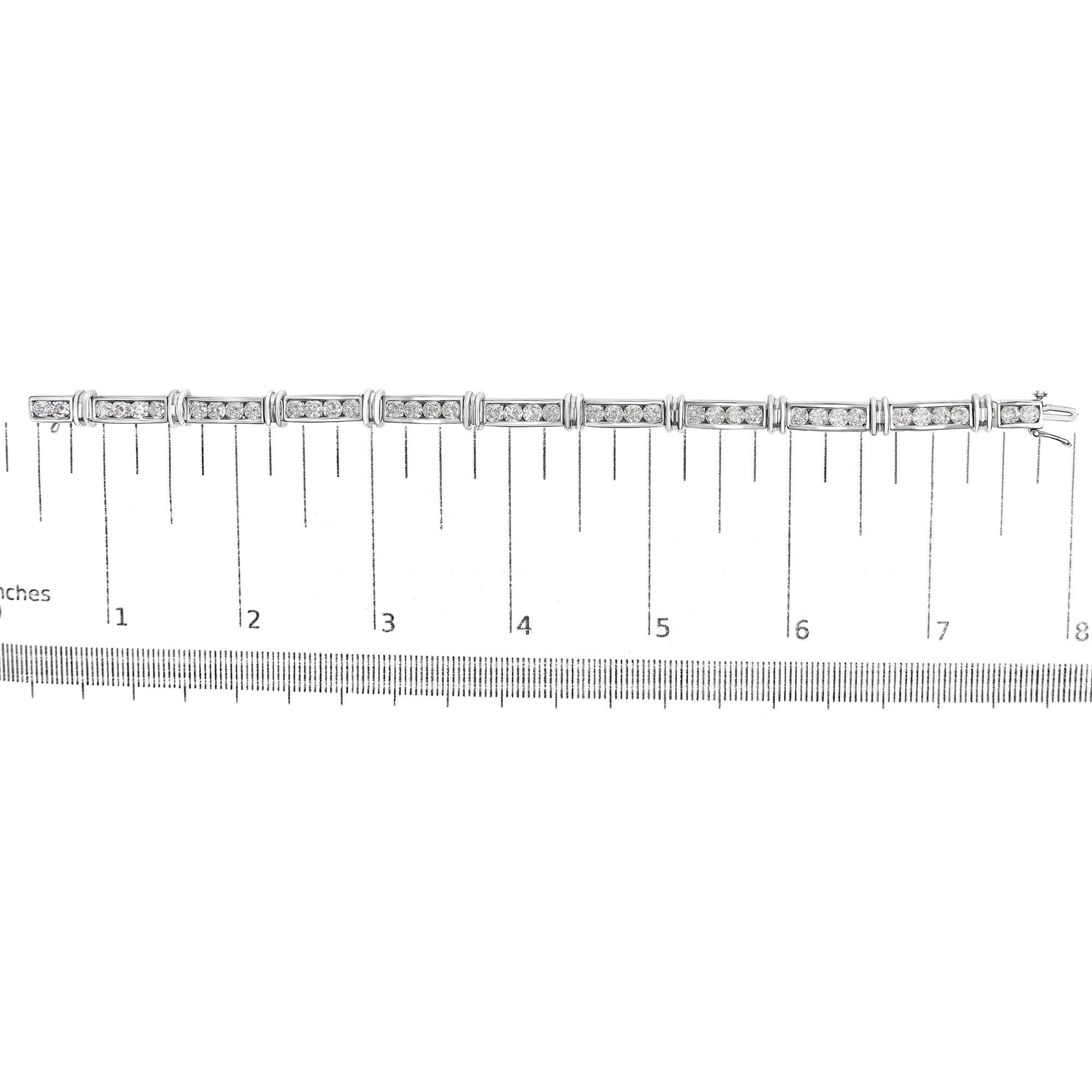 White bracelet with rectangular links set with round white gemstones in a channel setting, shown flat on a scale, top-down angle.