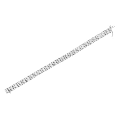 White metal bracelet with alternating rows of round prong-set white gemstones and baguette channel-set white gemstones, shown flat from a top angle.